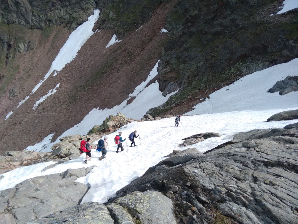 A party tiptoeing over the snow below the Simmingjochl