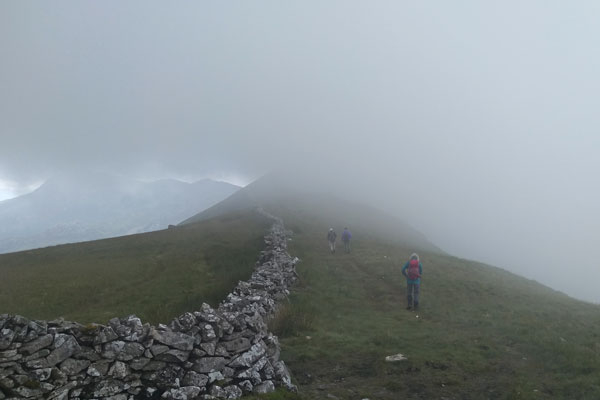 walkers in the mist on a mountain
